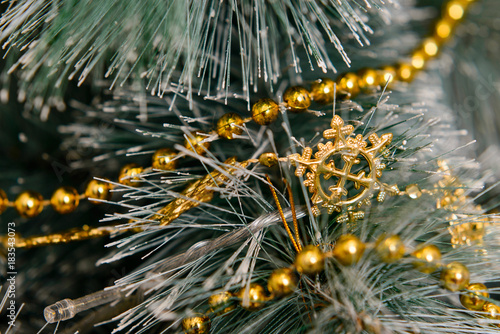 the beads on the branch of a Christmas tree