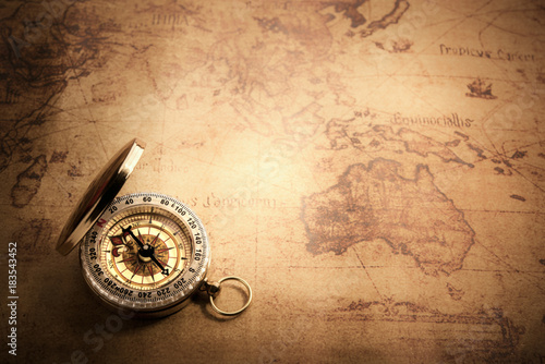 Retro compass with vintage map photo