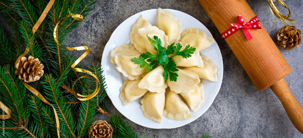 Christmas dumplings with decoration on a grey board. Top view. Stock