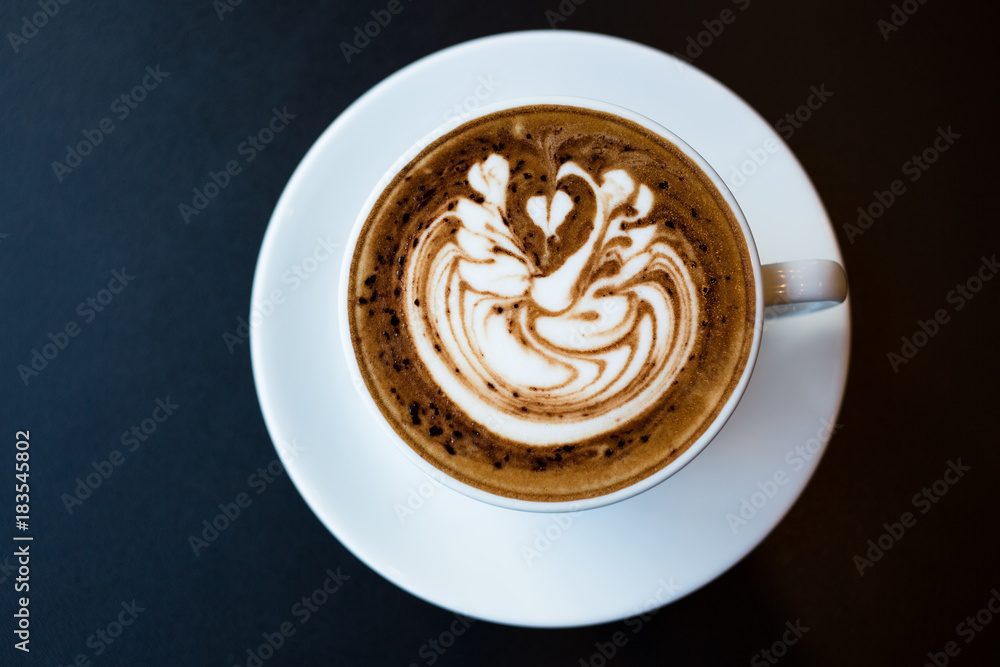 Cup of hot latte art coffee on black table Cup of hot latte art coffee on black table
