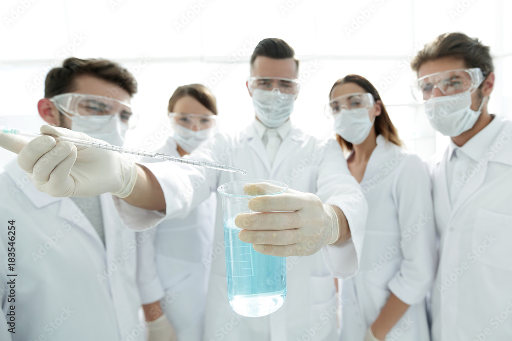 closeup of a group of medical workers working with liquids