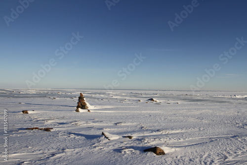 Winter arctic landscape with a small Inukshuk found near Arviat, Nunavut