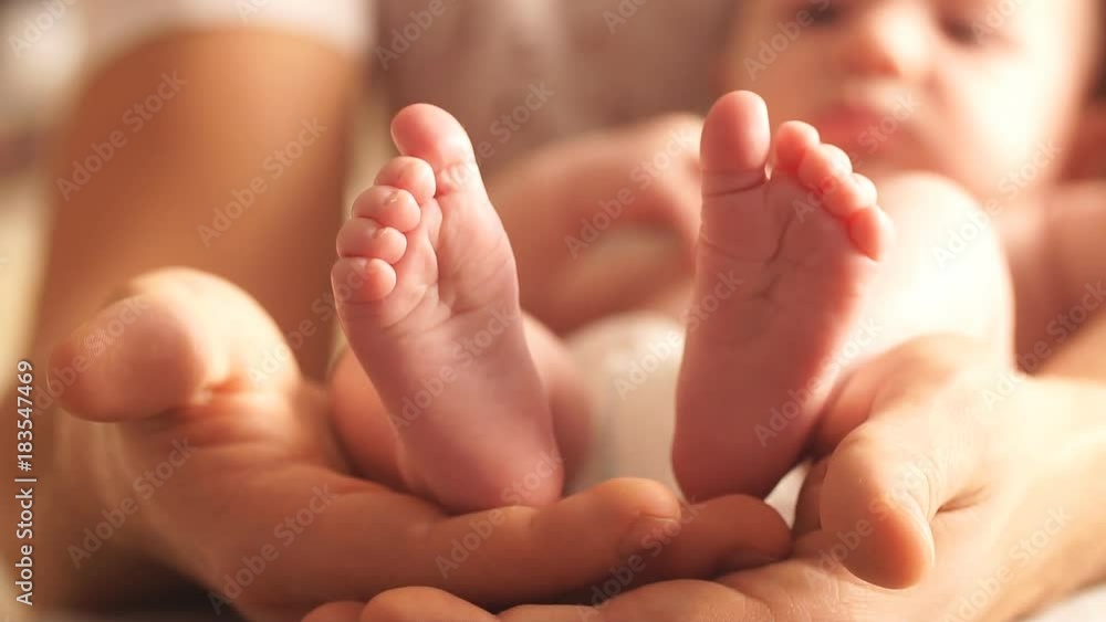 Father holding son's little feet in my hands. Happy family concept. Father holding son's little feet in my hands. Happy family concept.