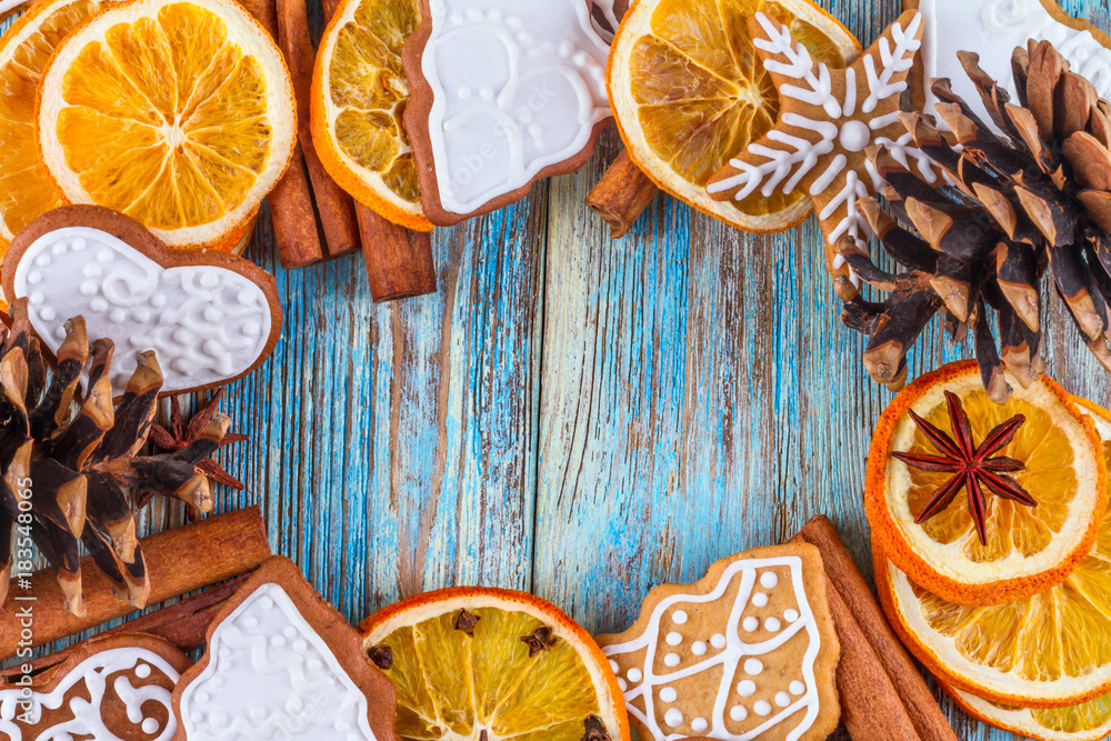 Christmas still life background with gingerbread cookies in decoration frame from festive ingredients on wooden boards Christmas still life background with gingerbread cookies in decoration frame from festive ingredients on wooden boards