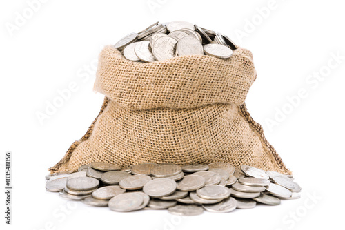 Money coins in burlap bag isolated on white background