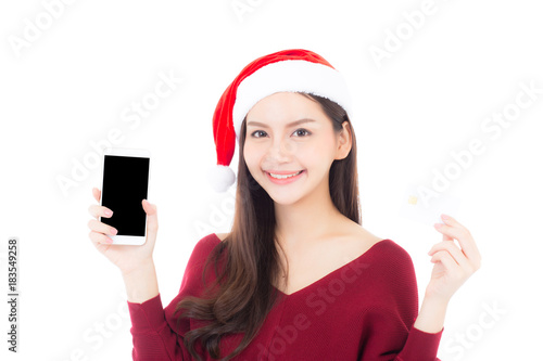 Beautiful asian young woman shopping with credit card and holding mobile phone in christmas holiday, girl with payment isolated on white background.
