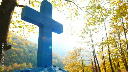 Greek blue cross on burial ground, autumnal forest scenery 4K