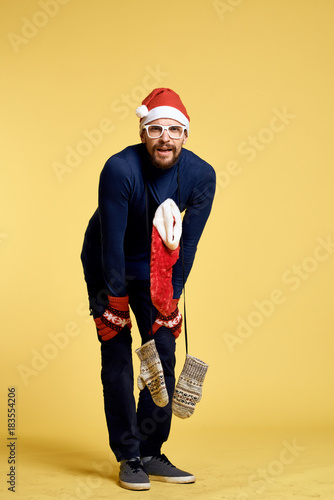 man in full growth leaned forward, light yellow background, new year, holiday, christmas © SHOTPRIME STUDIO