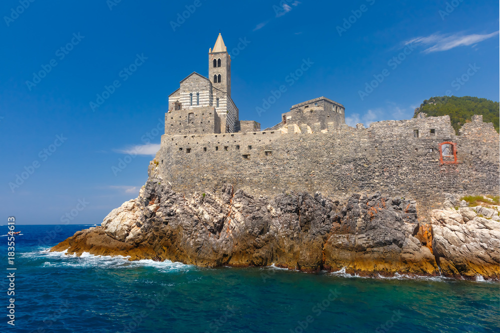 View from sea of Porto Venere with Gothic Church of St. Peter, Italian Riviera, Liguria, Italy.