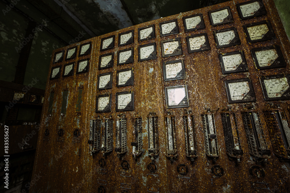 Old rusty electrical switchboard in abandoned factory or bunker