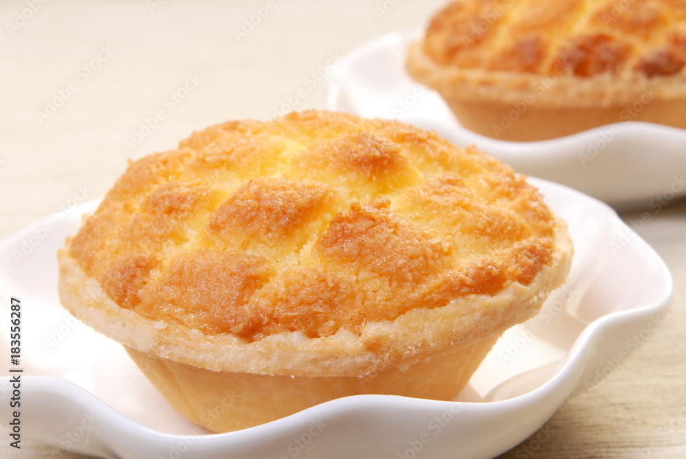 Coconut custard tarts on white plate Coconut custard tarts on white plate
