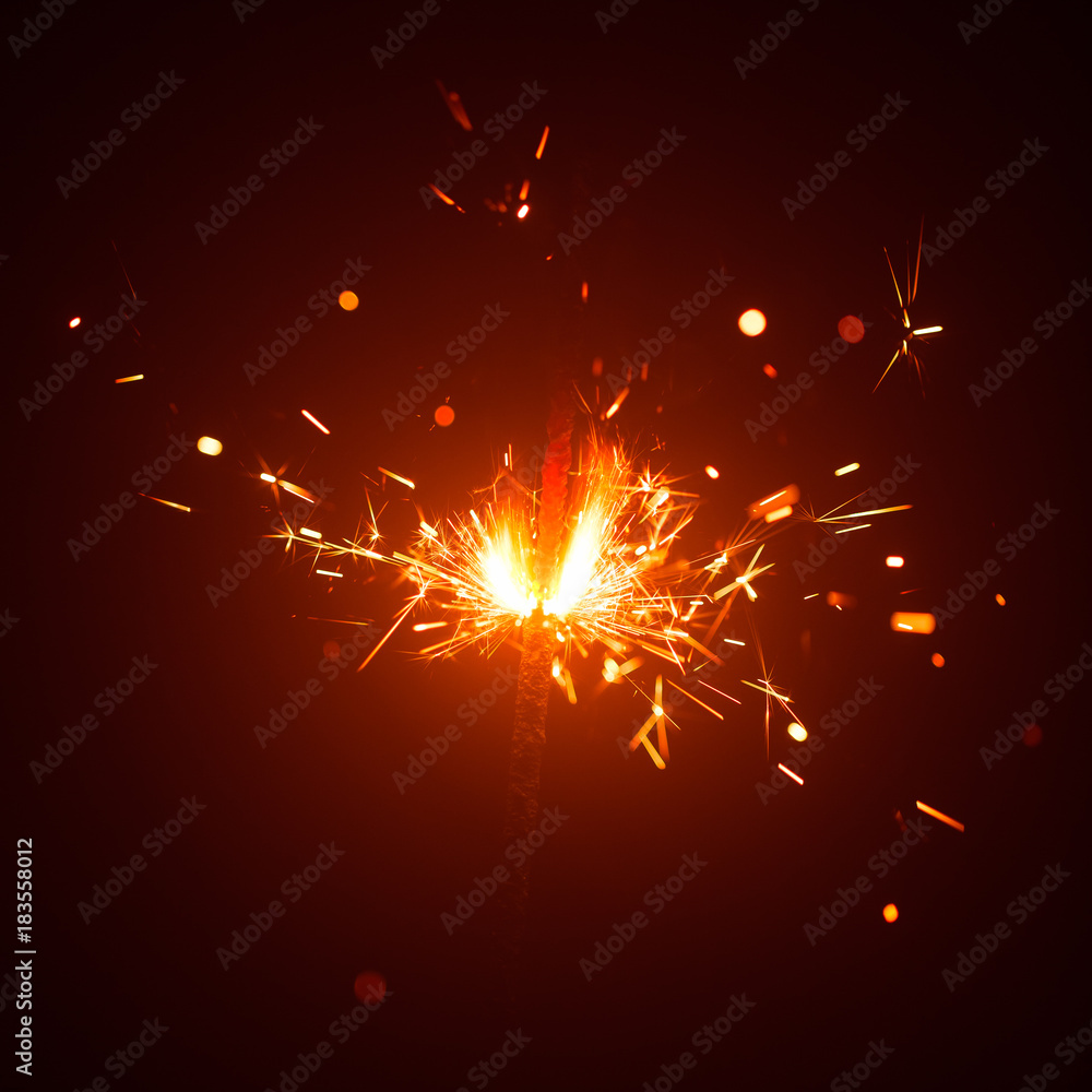 Obraz premium Christmas sparkler in haze with red light