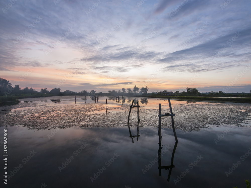Sunset reflected in a shrimp farm lake in eastern Thailand Sunset reflected in a shrimp farm lake in eastern Thailand