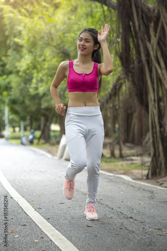 Girl is jogging in the morning in the park. © chamnan phanthong