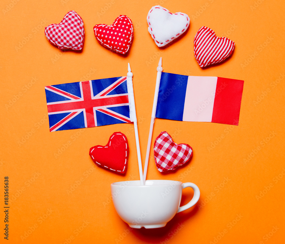 Obraz premium White cup and heart shapes with France and United Kingdom flags