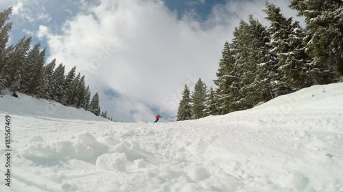 Man skiing on the prepared slope with fresh new powder snow in Tyrolian Alps, Zillertal, Austria 
 photo