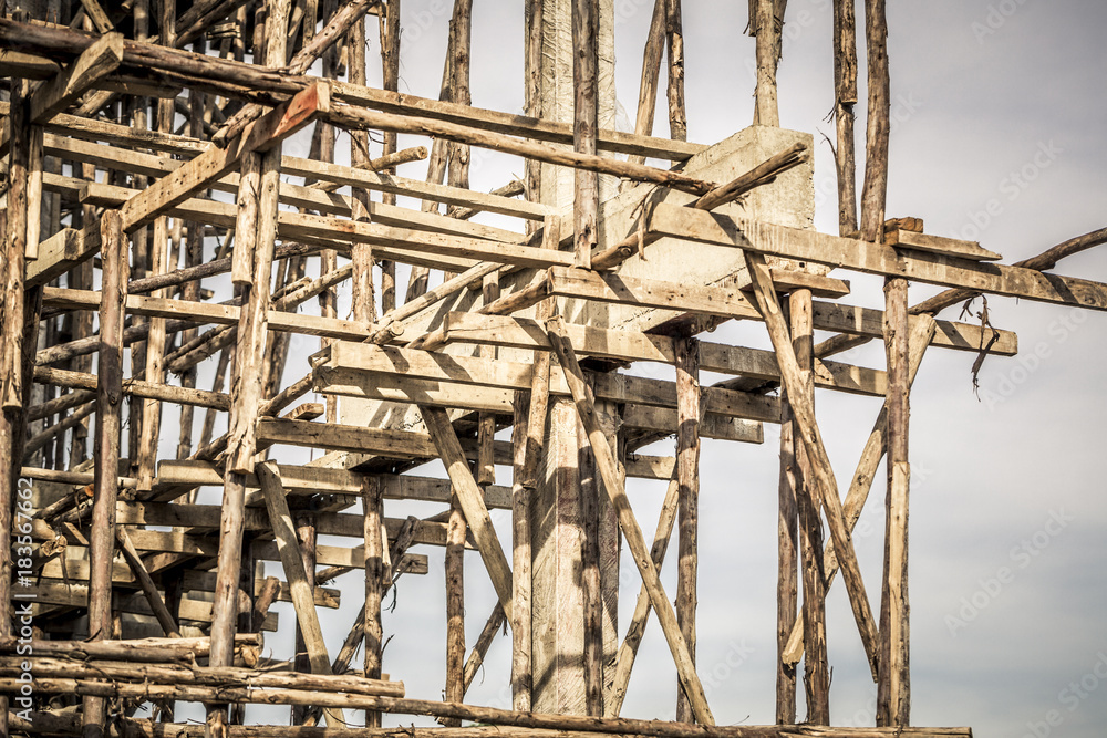 House under construction, showing the wooden scaffolding details. House under construction, showing the wooden scaffolding details.