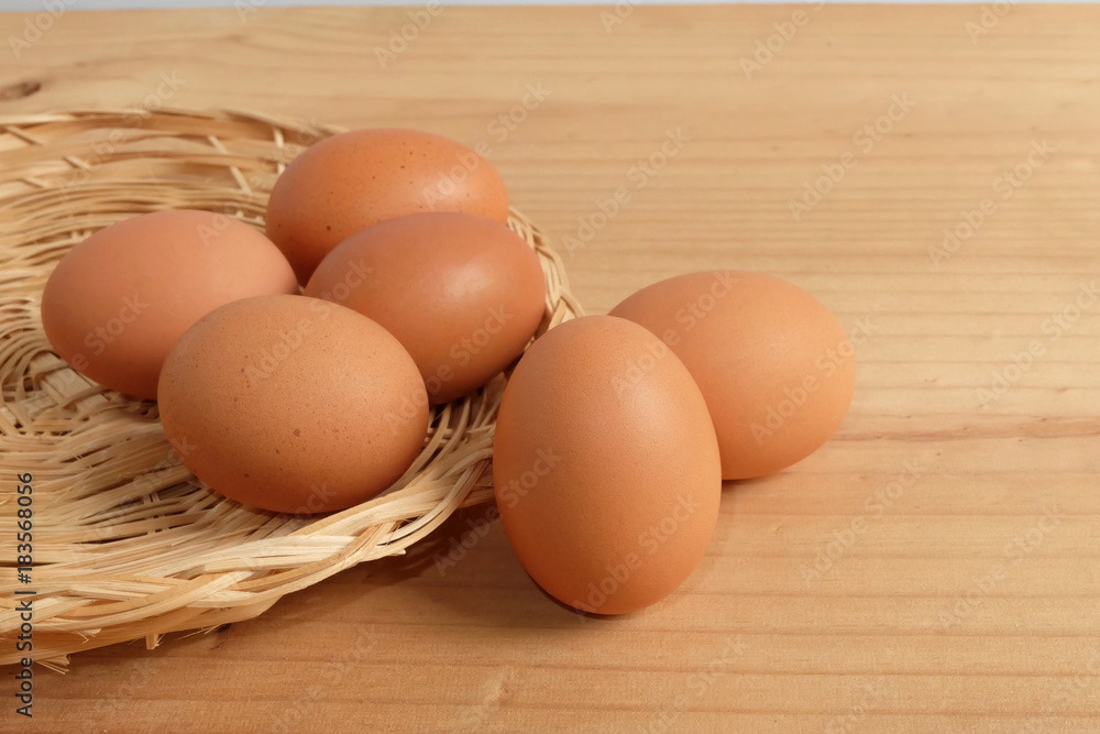 Eggs in the basket on Wooden floor Eggs in the basket on Wooden floor