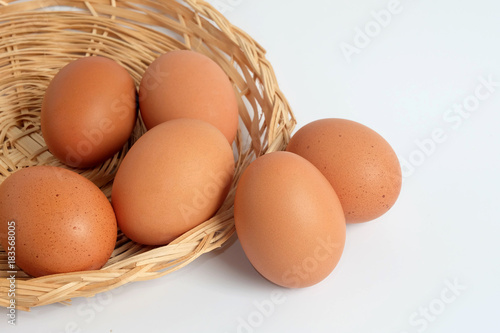 Eggs in the basket on white background