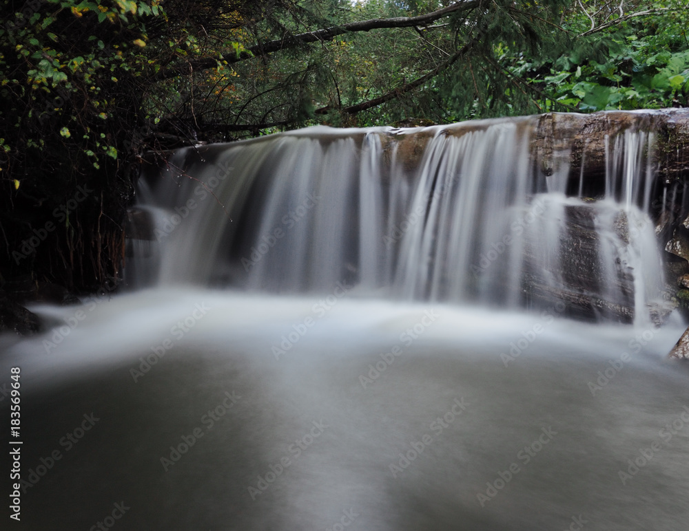 Fototapeta premium Waterfall at the carpatian mountains green forest