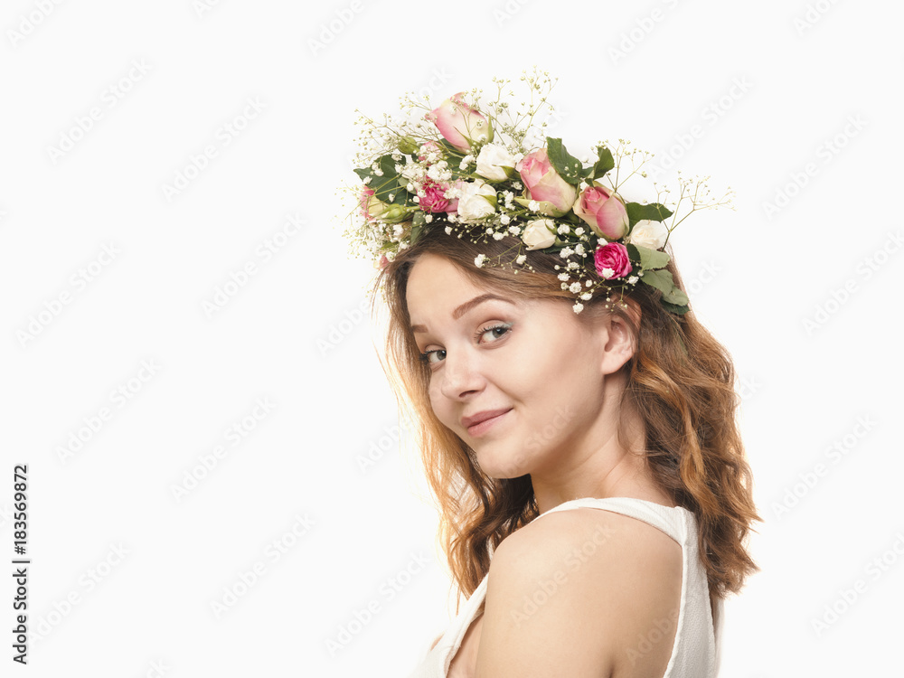 Beautiful young woman in a floral wreath of roses Beautiful young woman in a floral wreath of roses