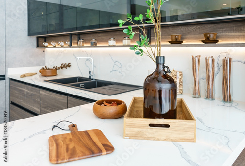 Modern, bright, clean kitchen interior with stainless steel appliances in a luxury apartment.