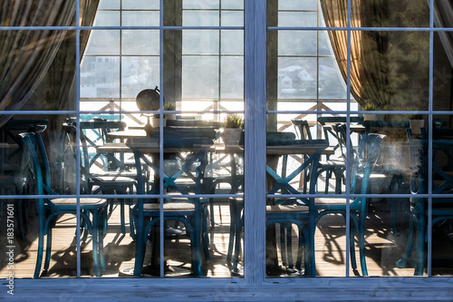 interior of cafe behind a glass facade at sunset