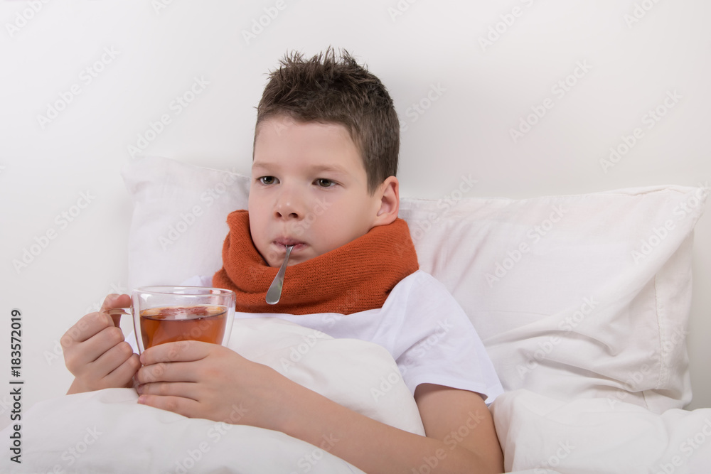 a sick boy drinks warm tea without getting out of bed a sick boy drinks warm tea without getting out of bed