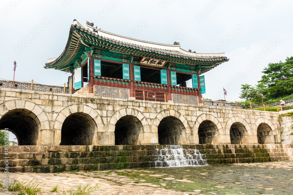 Suwon, South Korea - Hwahongmun Gate in Hwaseong Fortress, Korea’s World Heritage. (Sign board text is Suwon, South Korea - Hwahongmun Gate in Hwaseong Fortress, Korea’s World Heritage. (Sign board text is