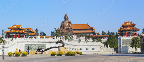Laozi statue and traveler in yuanxuan taoist temple guangzhou , China