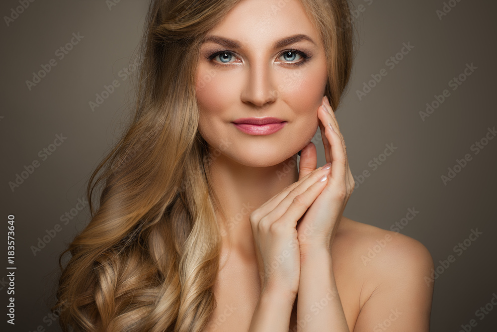 Fototapeta premium Beautiful Woman with Long Blonde Hair and Fresh Skin touching her Hand Her Face, Female Face Closeup