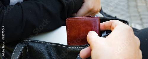 The panorama of Thief stealing the wallet from the bag, close-up