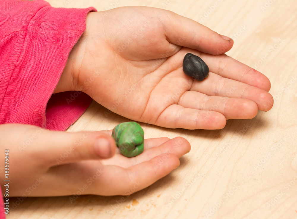 children's hands playing with plasticine children's hands playing with plasticine