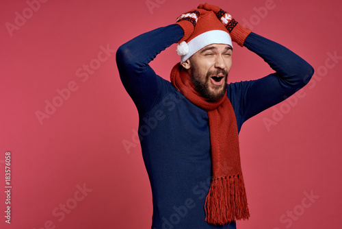 man holding hands on his head, red background, new year