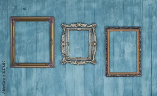 gallery of vintage victorian golden frames isolated on blue wooden wall