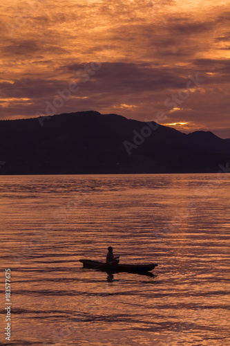 Sunset Sunrise with reflections at Lake Toba, Samosir Island, Indonesia.