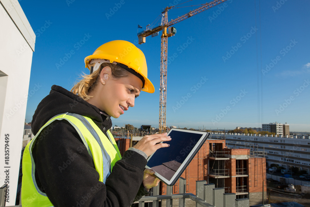 woman construction worker with hardhat using tablet pc woman construction worker with hardhat using tablet pc