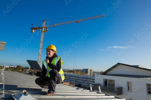 Woman engineer with safety hat is working at site