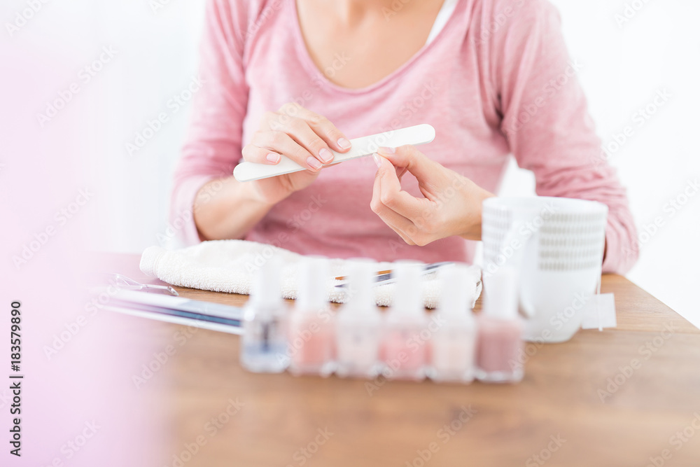 Female person hands with nail file, manicure Female person hands with nail file, manicure