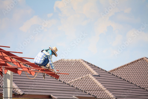 Wallpaper Mural welder workers installing steel frame structure of the house roof at building construction site Torontodigital.ca
