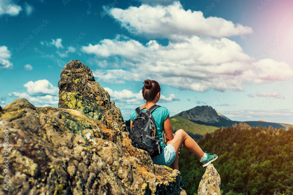 Woman Traveler with Backpack hiking in Mountains with beautiful landscape