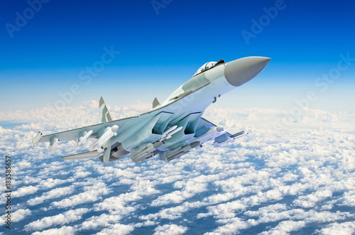 Fototapeta Naklejka Na Ścianę i Meble -  Military fighter jet plane above the clouds.