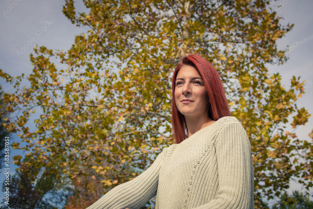 Portrait of beautiful redhead girl in the park. Portrait of beautiful redhead girl in the park.