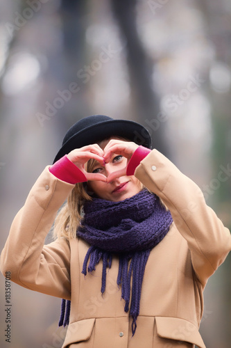 Cute smiley girl holding a heart - shape.