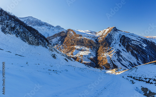 Snow-covered road in the mountains photo