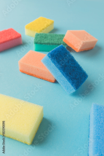 studio shot of colorful washing kitchen sponges, on blue