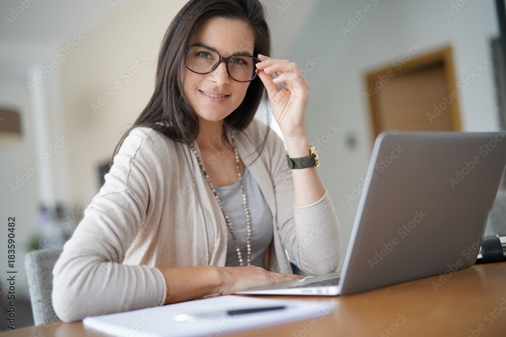 Portrait of smiling middle-aged active woman working from home Portrait of smiling middle-aged active woman working from home