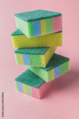 pile of colorful washing kitchen sponges, on pink