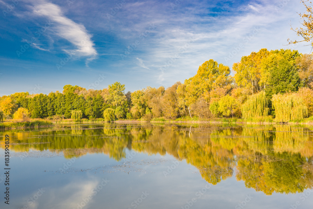 Beautiful autumn lake landscape. Colorful trees and blue sky Beautiful autumn lake landscape. Colorful trees and blue sky