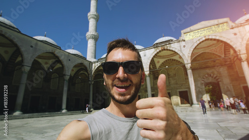 Photography Handheld of Happy tourist man having online video chat using his smartphone came